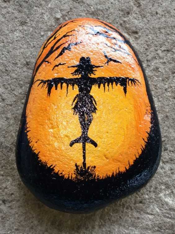 halloween painted rocks  scarecrow with orange glow