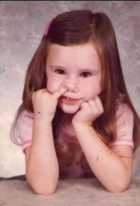 school photo fail with her finger in nose at the wrong time