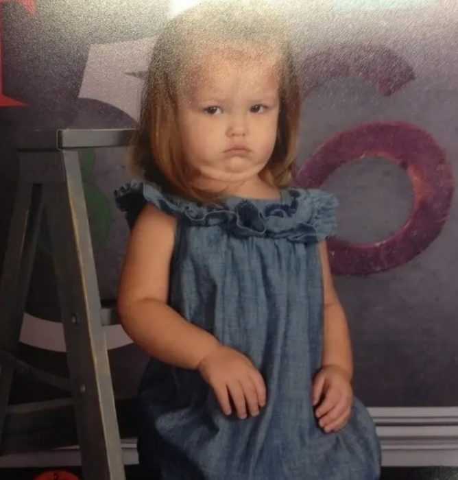 school picture fail of girl looking like she's holding something in