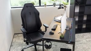 one of the top gaming chairs portrayed next to desk in front of window